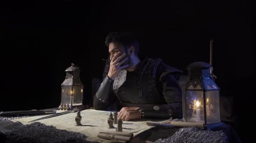 Man in Armor Studies Map by Candlelight