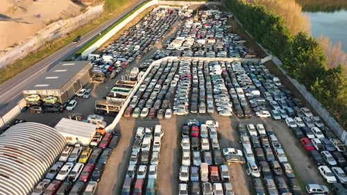 Aerial View of Big Parking Lot of Junkyard with Rows of Discarded Broken Cars