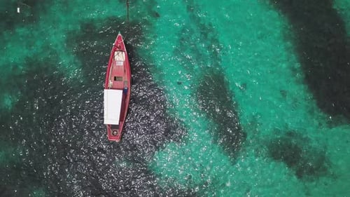Boats Anchoring in Turquoise Shallow Water by The Edge of Coral Reef. Aerial Top View