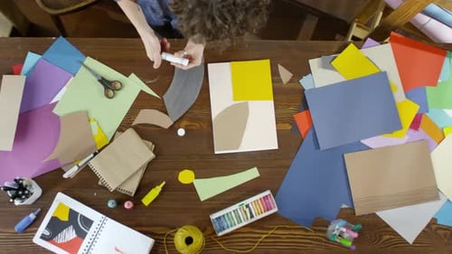 Adult Creating Art with Paper and Glue