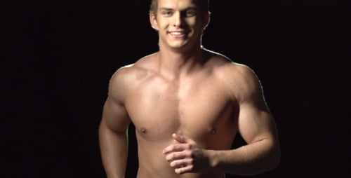 Athletic Man Runs Shirtless on Black Background