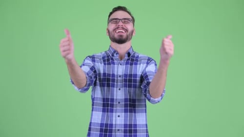 Excited Man Giving Thumbs Up Against Green