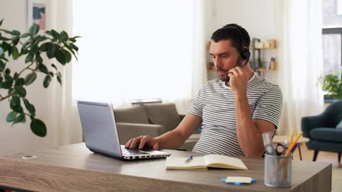 Man Working at Laptop in Bright Home Office