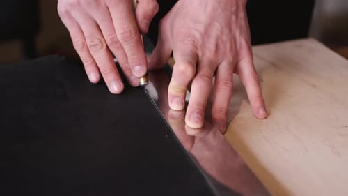Hands Cutting Material With Blade Close Up