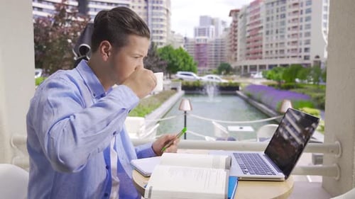 University student studying at cafe.