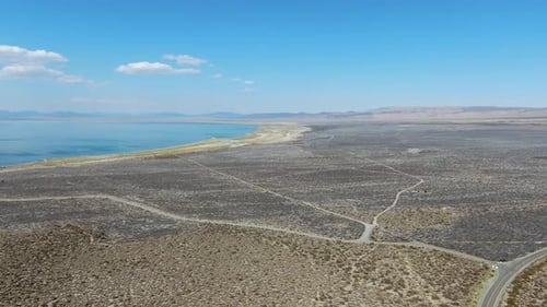 Aerial View of Dusty Dry Desert Land with Mono Lake on the Background, Mono County
