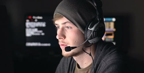 Intense Young Adult Gamer at Computer at Night