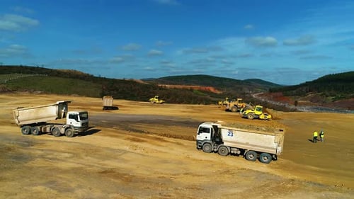 Dump Trucks Working On Construction Site