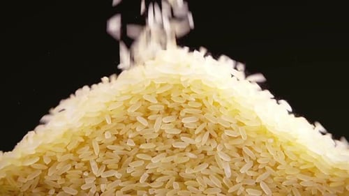 Rice Grains Pouring onto Pile Close Up