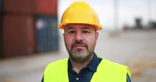 Man looking on camera working at freight terminal port on background