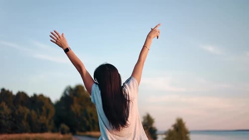 Back View Happy Travel Casual Woman Relaxing with Raising Hands Walking Mountain Beach in Sunset