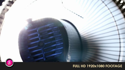 Portable Fan Spinning in Front of Light