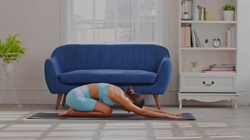 Side view Asian woman wearing blue sportwear doing Yoga exercise,Yoga Child’s pose