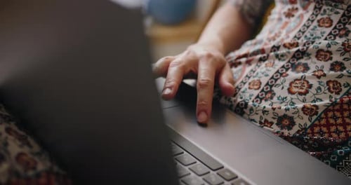 Hand Using Touch Pad on Laptop at Home