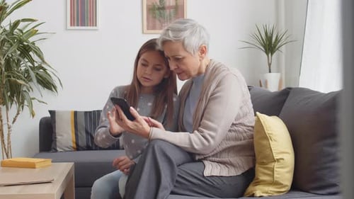 Granddaughter Teaches Grandmother to Use Smartphone