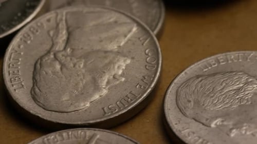 Rotating stock footage shot of American nickles (coin - $0.05) - MONEY 0192