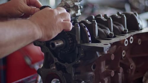 Oil Pump Chain Of Refurbished Car Engine Being Repaired At Workshop Bench