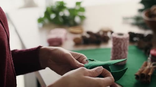 Close up of woman's hands preparing Christmas decoration. Shot with RED helium camera in 8K