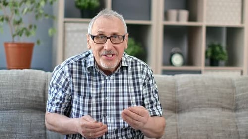 Adult Man Talking on Sofa in Indoor Setting