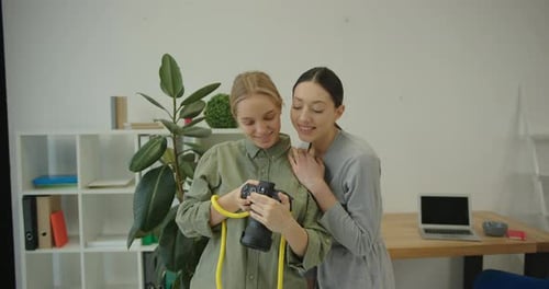 Two Women Looking at Camera Screen Indoors