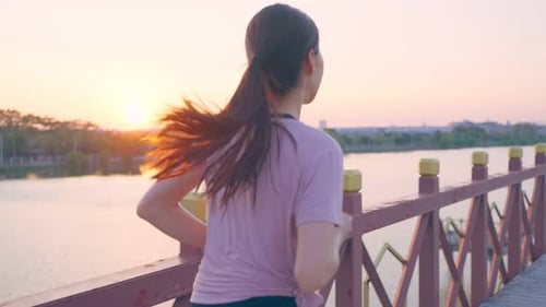 Asian young beautiful sport woman running on street in public park.