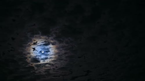 Full Moon Through Clouds at Night