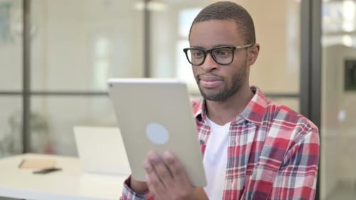 Man Working on Tablet in Modern Office
