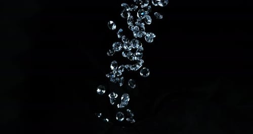 Falling Sparkling Gems on Black Background