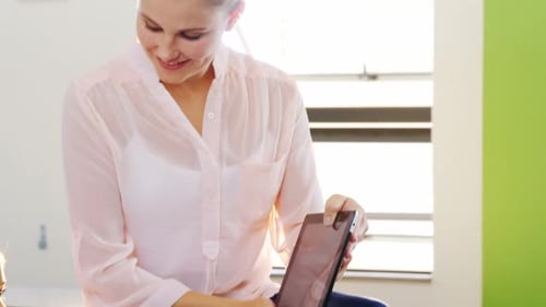 Teacher and Student Using Tablets in Classroom
