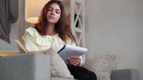 Young Woman Studying and Taking Notes at Home