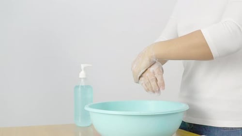 Adult Washing Hands with Soap in Studio