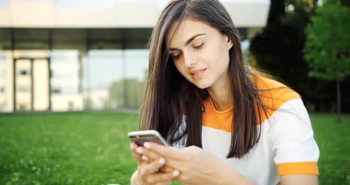 Young Woman Using Cell Phone Outside