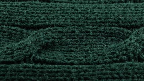 Pigtails on Green Knitwear Fabric Texture. Machine Knitting Texture Macro Snapshot.