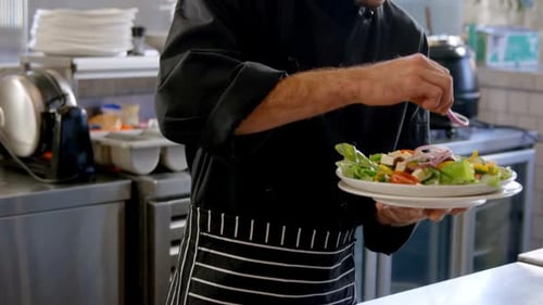 Chef Prepares a Salad in Commercial Kitchen