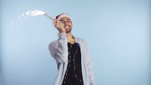 Cheerful Man Celebrates Christmas with a Sparkler