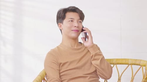 Young Adult Male Talking on Cell Phone Indoors