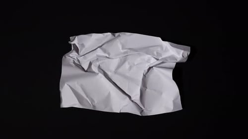 Paper Unfolding and Crumpling on Black Background