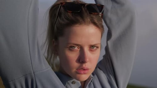 Woman with Sunglasses Posing Outdoors on Hillside