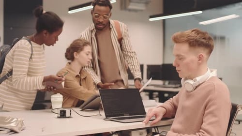 Programmer Writing Code on Laptop