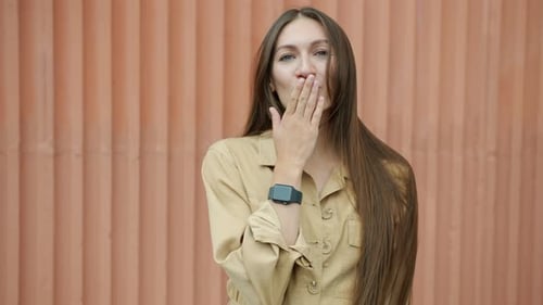 Woman Smiling and Giving an Air Kiss