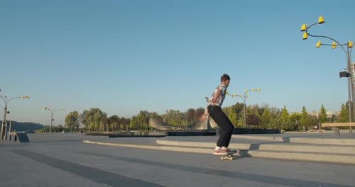 Skater Boy Is Doing Tricks at the Park, Kickflip and Jumps,