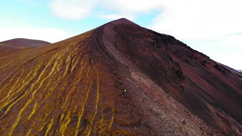 Anonymous travelers climbing up rock