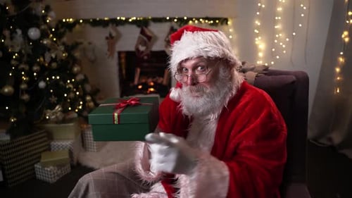 Santa Claus Holding a Gift in Festive Room
