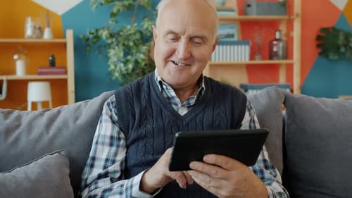 Senior Man Using Tablet at Home