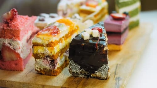 Colorful Cake Slices on Wooden Board Close Up