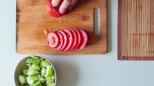 Top View of a Male Hands Citting Tomato for Salad.