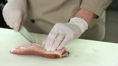 Chef Preparing Duck Breast with Sharp Knife