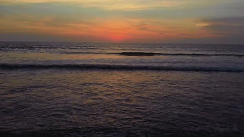 Flight at Sunset Overlooking the Indian Ocean in Bali Indonesia