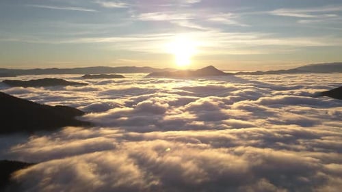 Aerial View of Mountains and Clouds at Sunrise