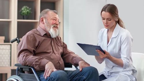 Senior Man in Wheelchair Consulting with Doctor